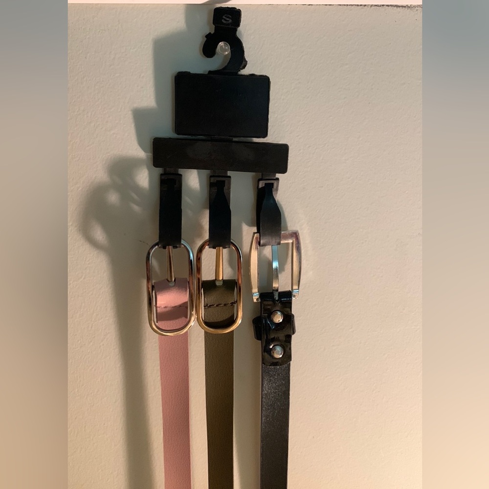pack of three belts- pink, black, and greenish brown.
